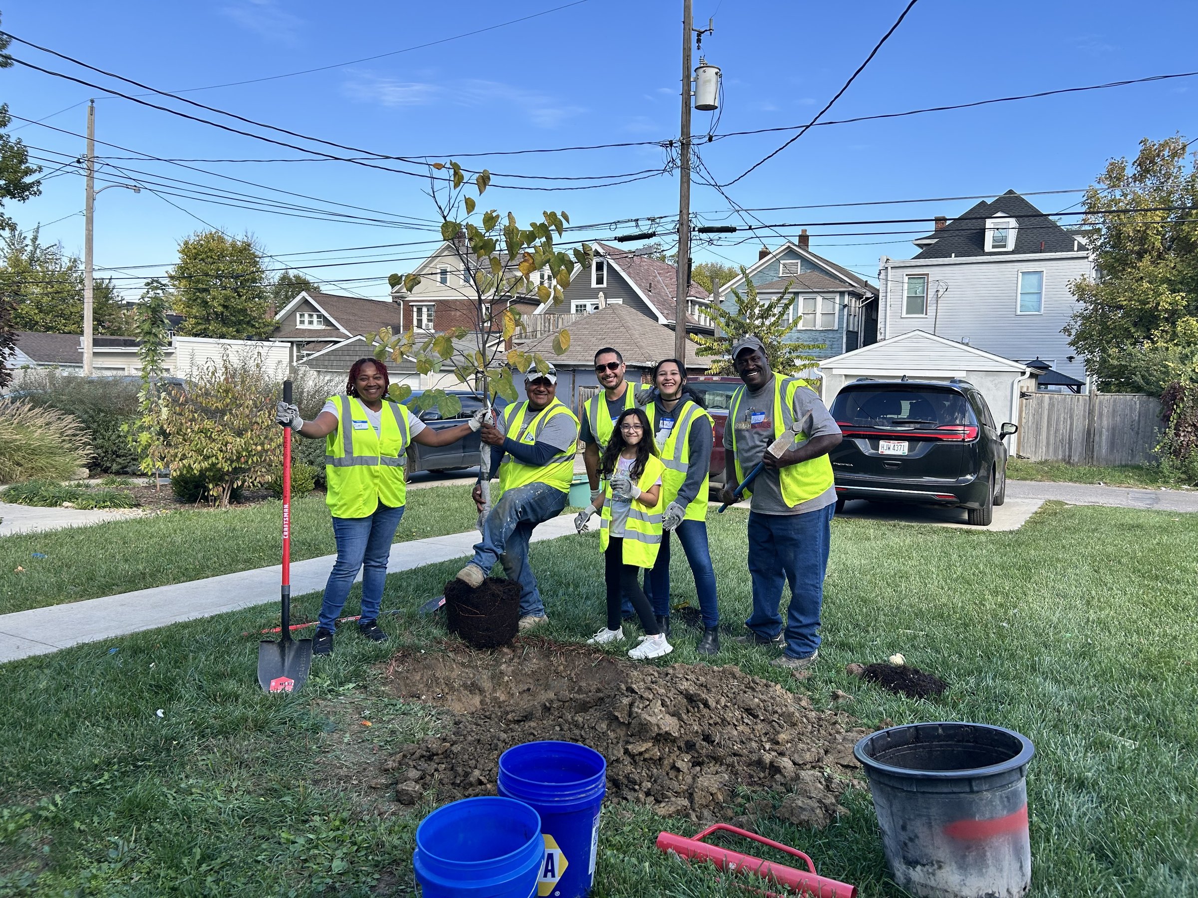 Neighborhood volunteers planting a tree together through the Columbus Tree Assistance Program